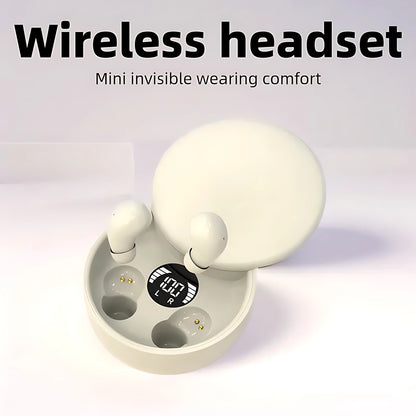 Beige mini invisible wireless earbuds inside a round charging case with LED battery display screen.
