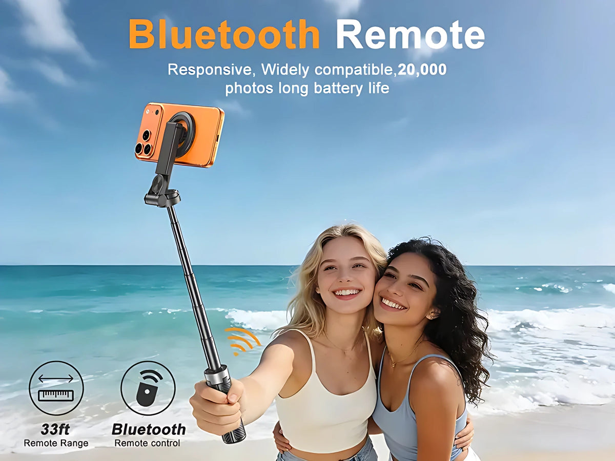 Two friends capturing beach selfie outdoors using magnetic selfie stick with wireless Bluetooth remote shutter.